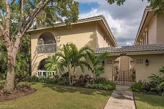2096 Alamanda Drive, Unit 102 Naples, FL 34102 - Photo 1 of 23 front view of house with a yard
