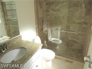2096 Alamanda Drive, Unit 102 Naples, FL 34102 - Photo 14 of 23 a bathroom with a toilet sink and shower