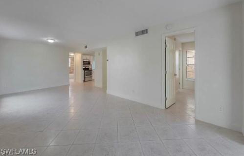 2096 Alamanda Drive, Unit 102 Naples, FL 34102 - Photo 15 of 23 a view of empty room with wooden floor