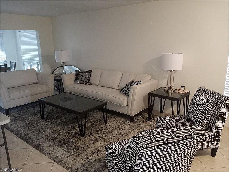 2096 Alamanda Drive, Unit 102 Naples, FL 34102 - Photo 16 of 23 a living room with furniture
