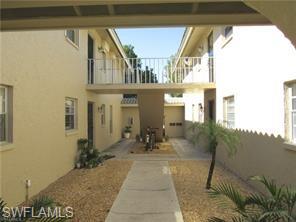 2096 Alamanda Drive, Unit 102 Naples, FL 34102 - Photo 17 of 23 a house view with a outdoor space
