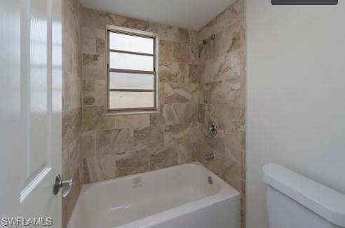 2096 Alamanda Drive, Unit 102 Naples, FL 34102 - Photo 21 of 23 a bathroom with a bathtub and window