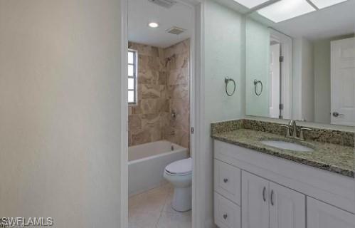 2096 Alamanda Drive, Unit 102 Naples, FL 34102 - Photo 8 of 23 a bathroom with a granite countertop sink a toilet and shower