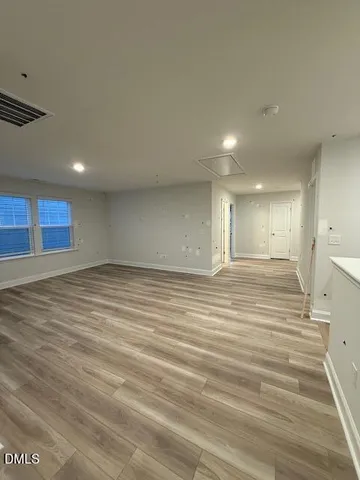 a view of a room with wooden floor