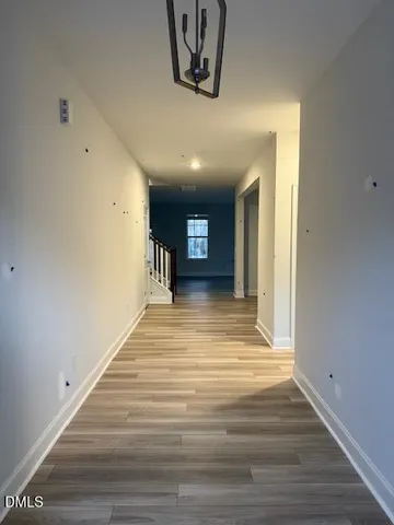 a view of a room with wooden floor and a window