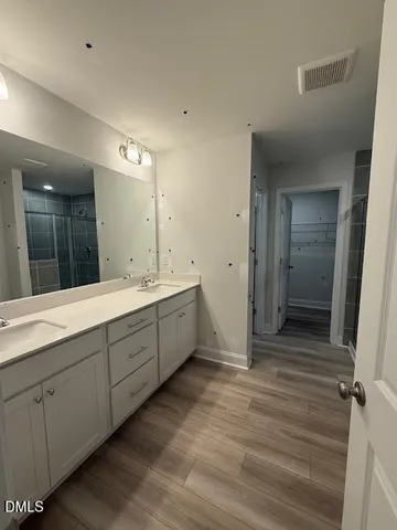 a bathroom with a double vanity sink and mirror