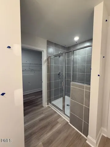 a bathroom with a shower and a glass door