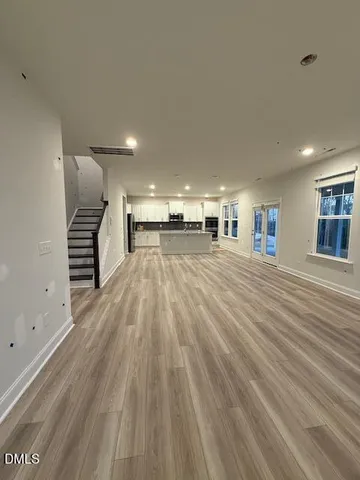 a view of a room with wooden floor