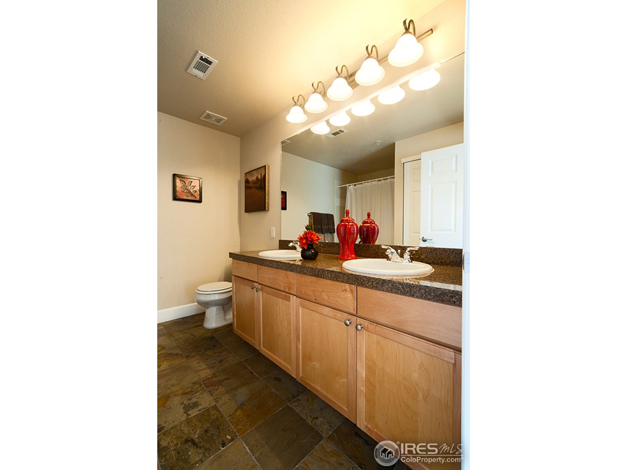4500 Baseline Road, Unit 4104 Boulder, CO 80303 - Photo 7 of 11 a bathroom with a double vanity sink mirror and toilet