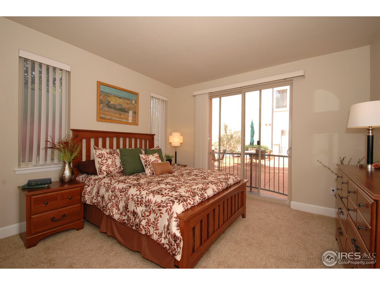 4500 Baseline Road, Unit 4104 Boulder, CO 80303 - Photo 9 of 11 a bedroom with a bed and a tv on the dresser