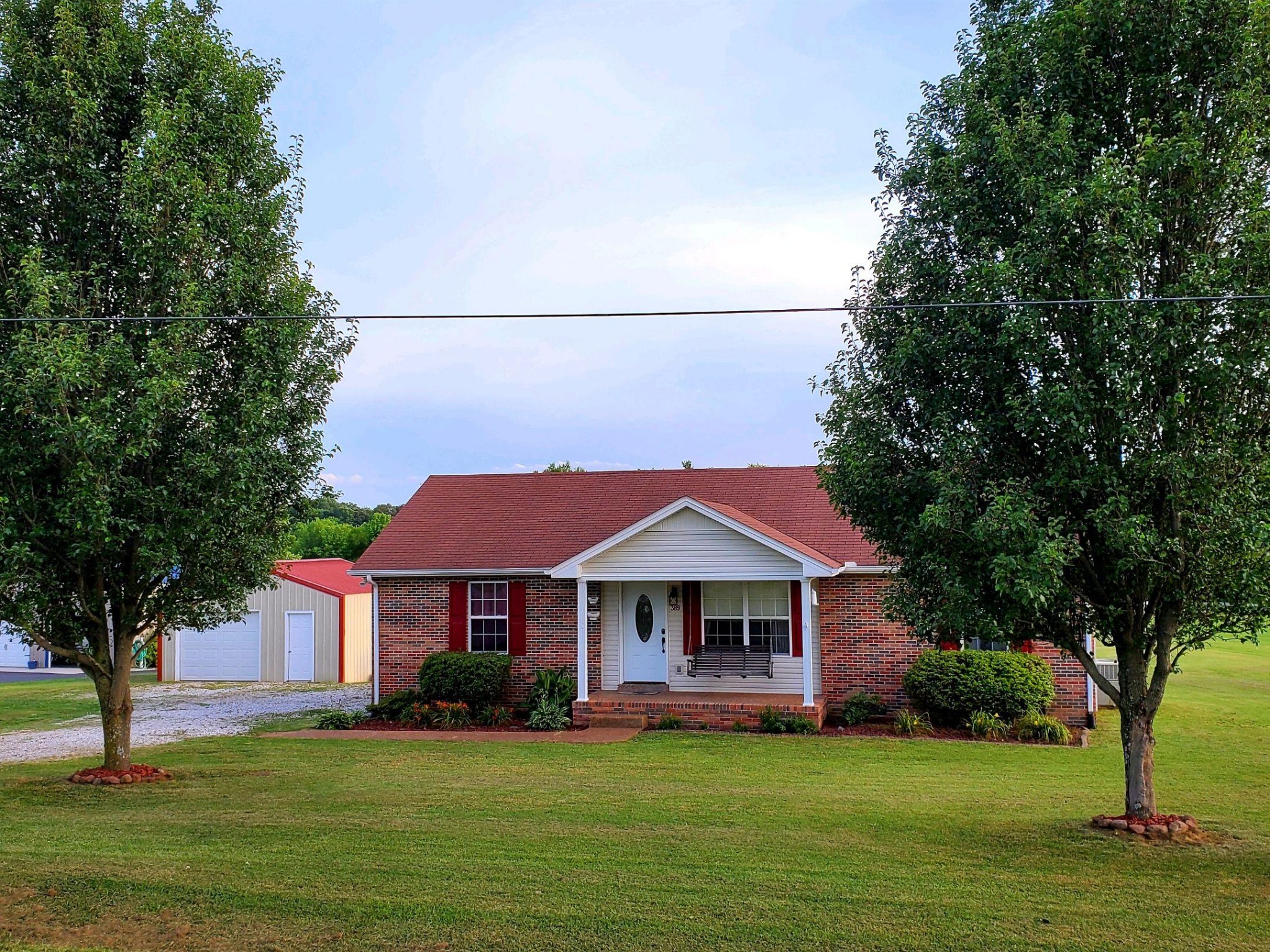 389 Corinth Road Portland, TN 37148 - Photo 4 of 6 a front view of a house with a garden