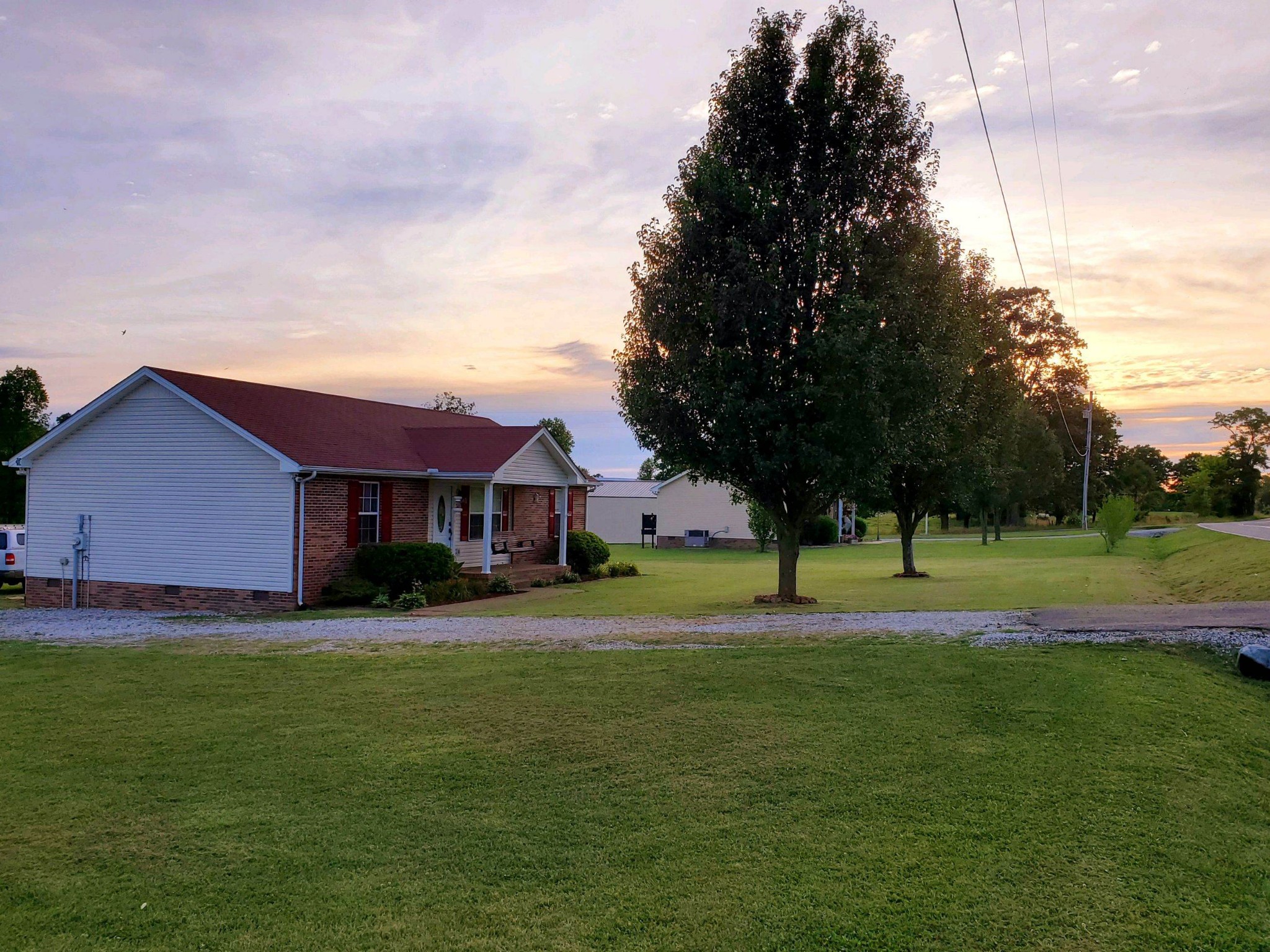 389 Corinth Road Portland, TN 37148 - Photo 5 of 6 a view of a big house with a big yard and palm trees
