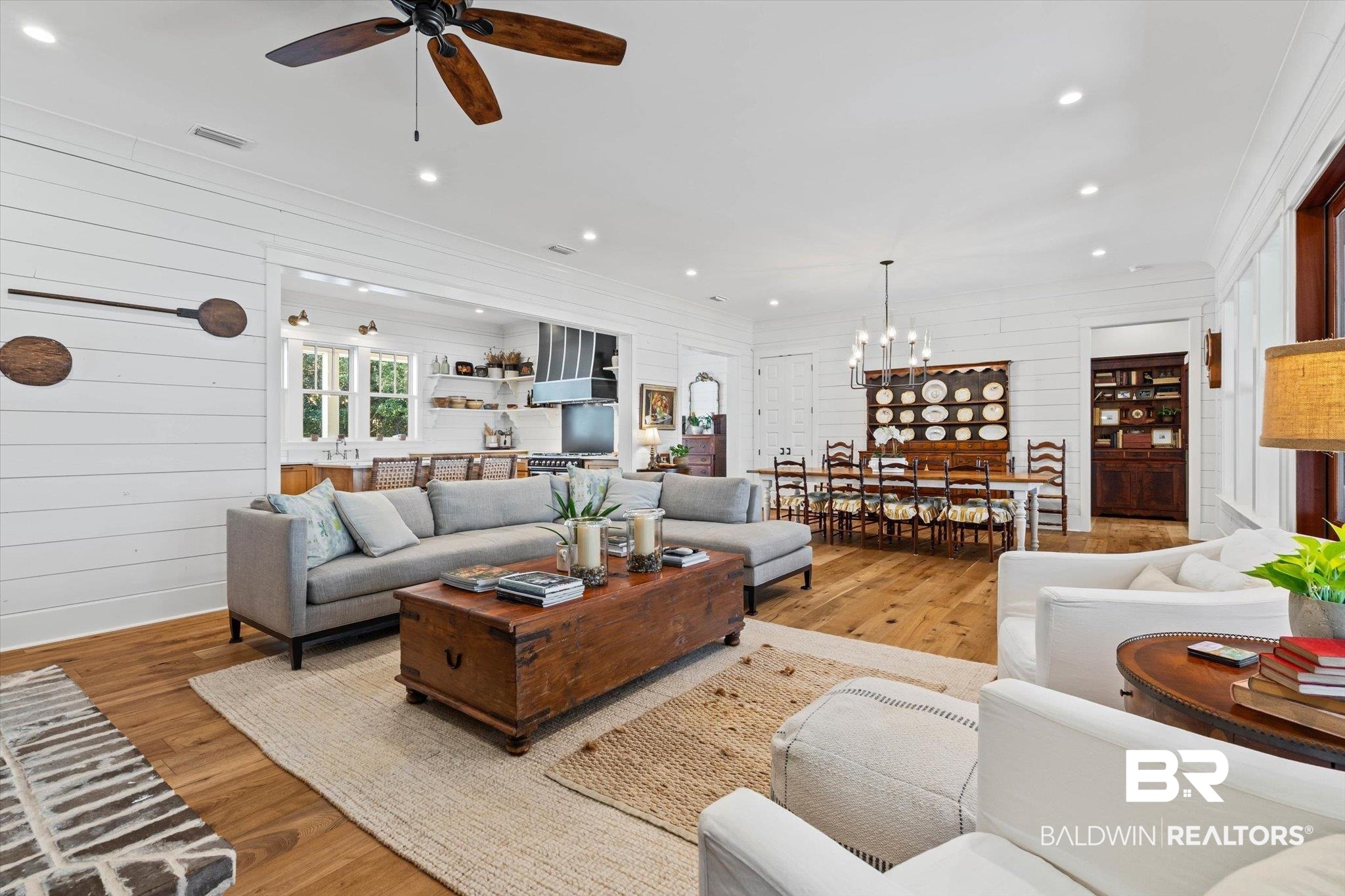 2415 Venetia Road Mobile, AL 36605 - Photo 5 of 50 Living room with light wood-type flooring, wooden walls, recessed lighting, ceiling fan, and a chandelier