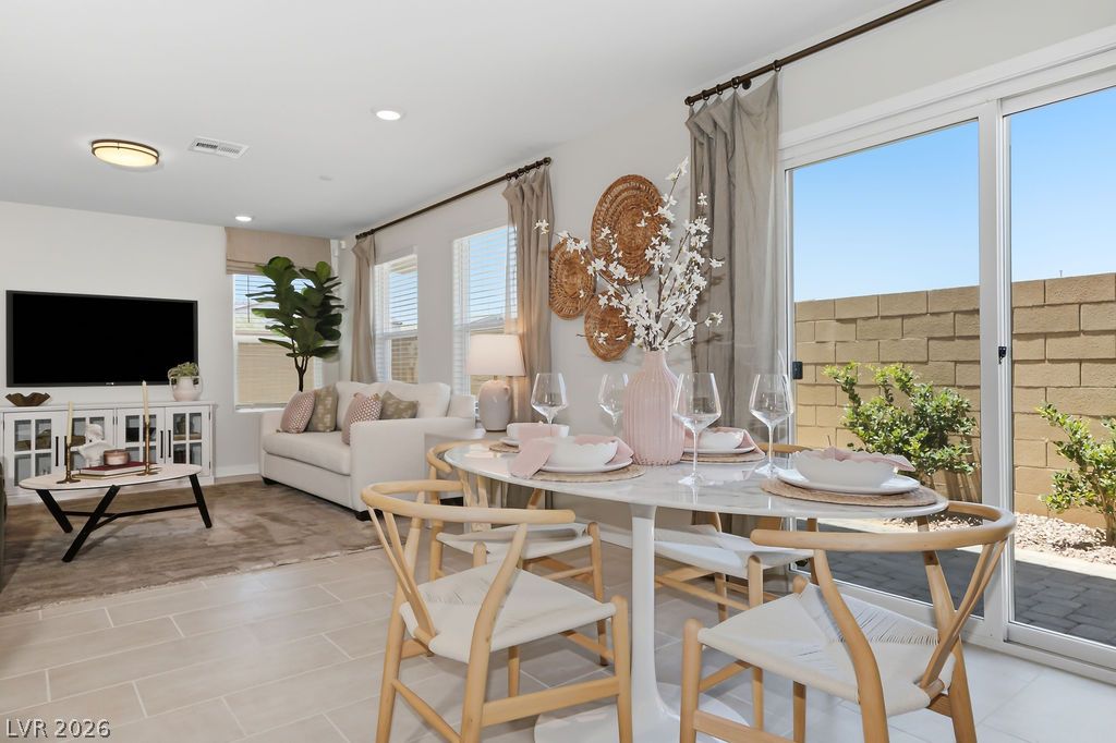 913 Cadence View Way Henderson, NV 89011 - Photo 15 of 46 An open concept living and dining area boasts tile flooring and a seamless transition to the outdoor space.