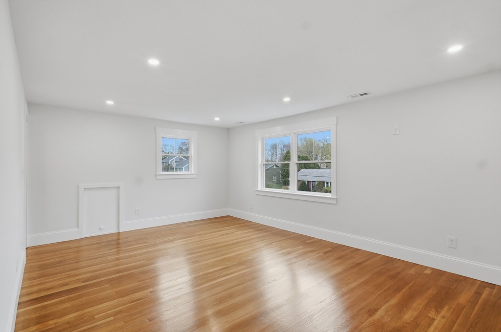 105 Stafford Road Lowell, MA 01852 - Photo 16 of 42 a view of empty room with wooden floor and fan