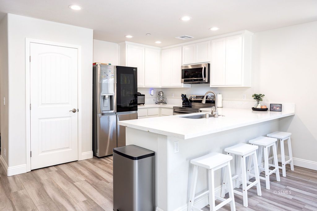 1229 South Ranger Street Ridgecrest, CA 93555 - Photo 6 of 36 a kitchen with stainless steel appliances a sink and refrigerator