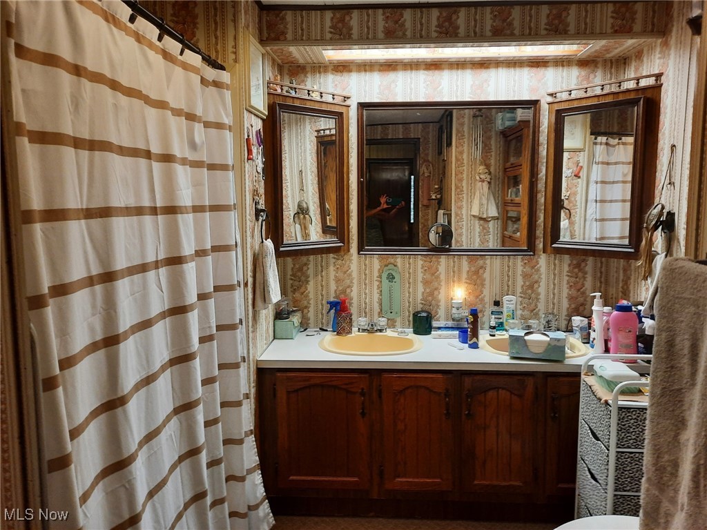 110 West Lebanon Road, Unit 70 Dalton, OH 44618 - Photo 9 of 13 Bathroom with wallpapered walls, vanity, and curtained shower