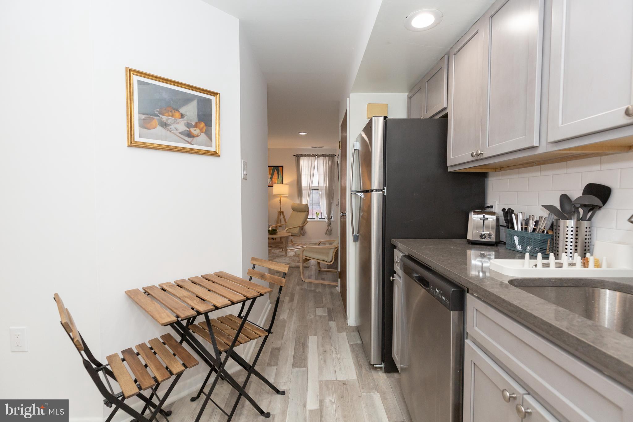 1915 Pemberton Street, Unit 2 Philadelphia, PA 19146 - Photo 8 of 16 a kitchen with stainless steel appliances granite countertop a refrigerator and a stove top oven