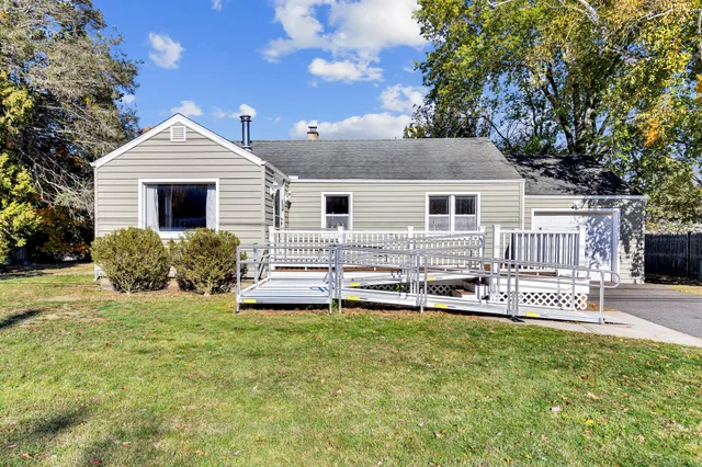 a front view of a house with a yard table and chairs