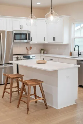 a kitchen with a sink cabinets and window