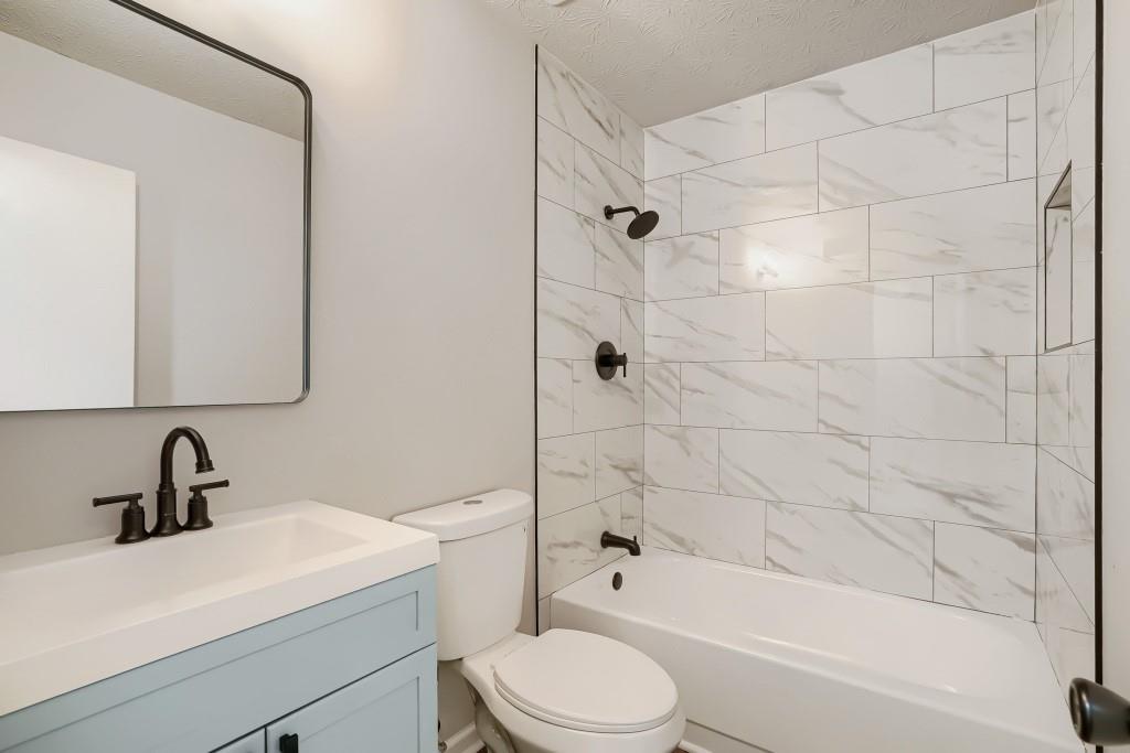 2021 Irwin Bridge Road Northwest Conyers, GA 30012 - Photo 37 of 43 a bathroom with a sink toilet and shower
