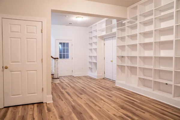 a living room with furniture and a clock