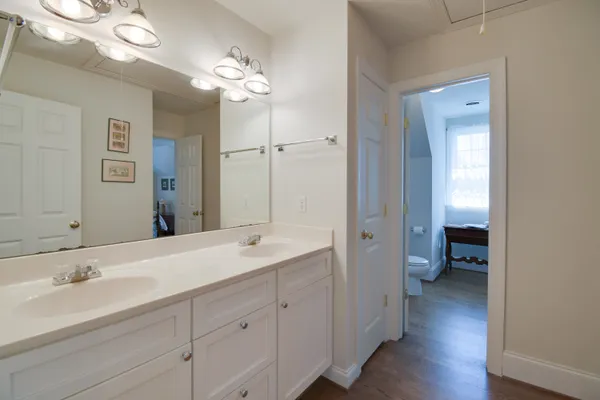 a white toilet sitting next to a bathroom sink