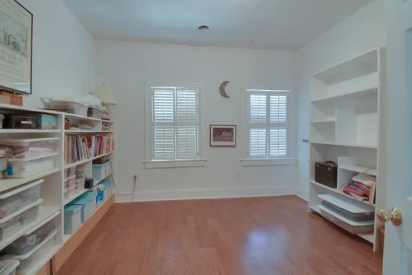 a view of a room with gym equipment and a fireplace