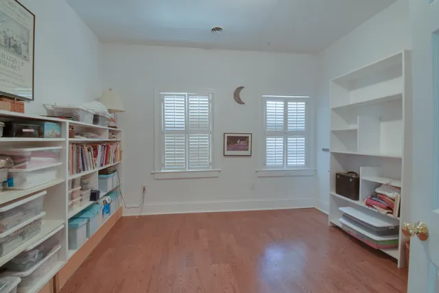 a view of a room with gym equipment and a fireplace