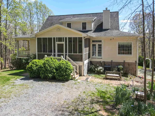 a view of a lush green hillside and houses