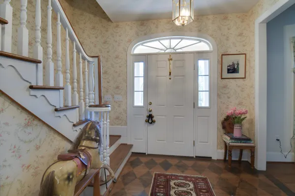 a view of a livingroom with wooden floor and furniture