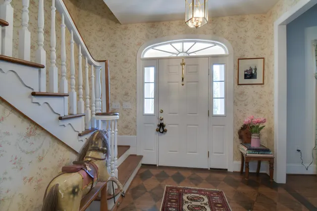 a view of a livingroom with wooden floor and furniture