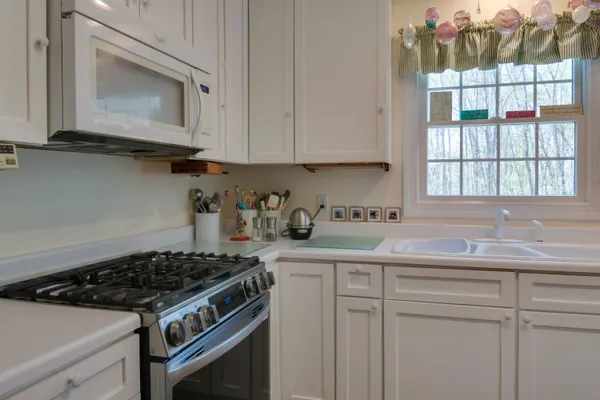a kitchen with a refrigerator and a sink