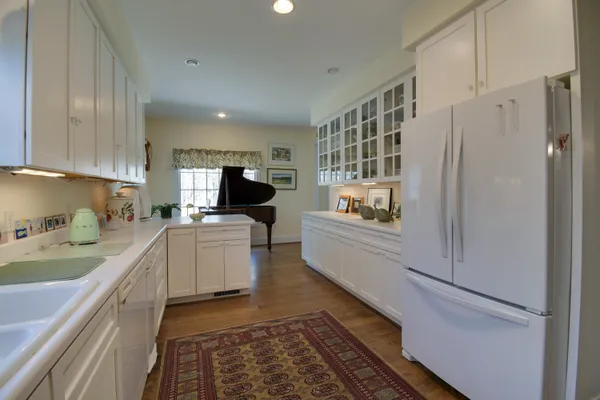 a view of a a dining room with furniture window and wooden floor