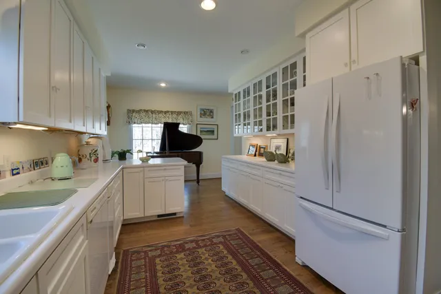 a view of a a dining room with furniture window and wooden floor