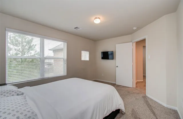 a living room with furniture and a ceiling fan