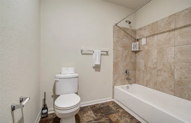 a view of a house with a small yard and a garage