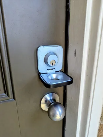 a view of a dining room with furniture a chandelier and a window