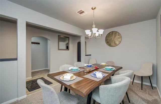 a kitchen with stainless steel appliances granite countertop a sink a stove top oven a refrigerator and island