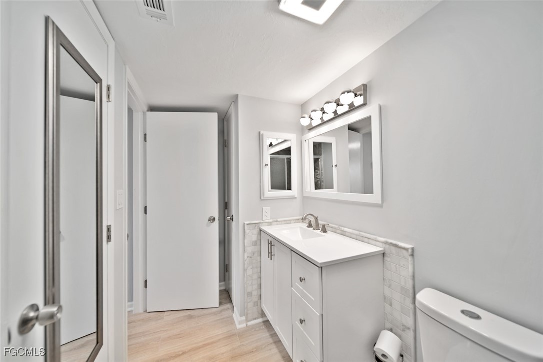 16881 Davis Road, Unit 721 Fort Myers, FL 33908 - Photo 13 of 23 a bathroom with a toilet sink and mirror