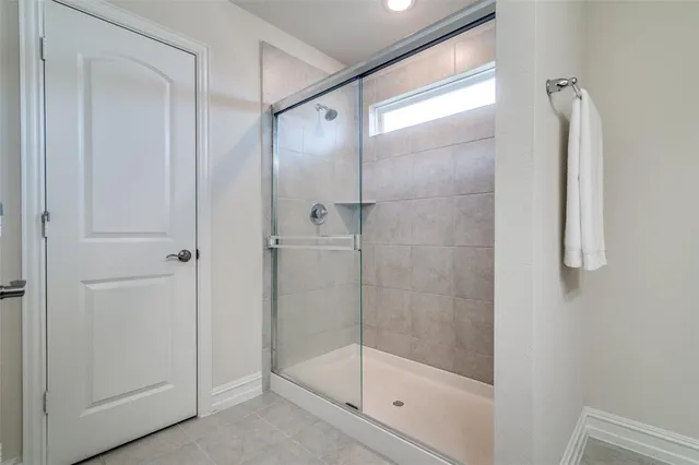 a bathroom with a glass shower door