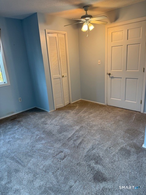 85 River Road, Unit M4 Essex, CT 06426 - Photo 8 of 9 an empty room with windows and fan