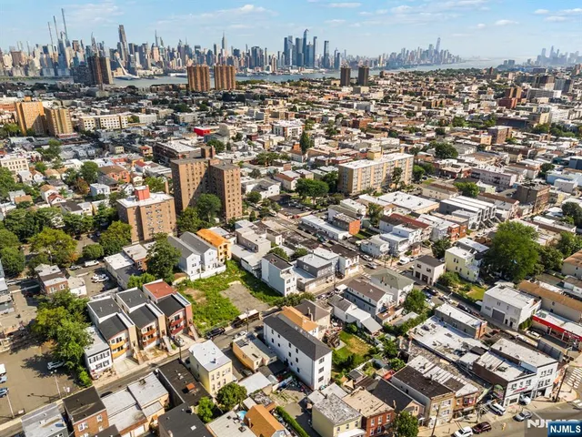 an aerial view of residential building with outdoor space and lake view