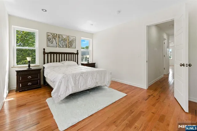 a bathroom with a granite countertop toilet sink and mirror