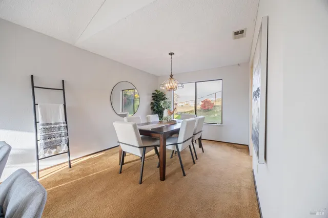 a dining room with furniture and a window