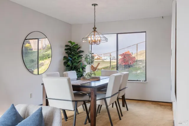 a dining room with furniture a mirror and a wooden floor