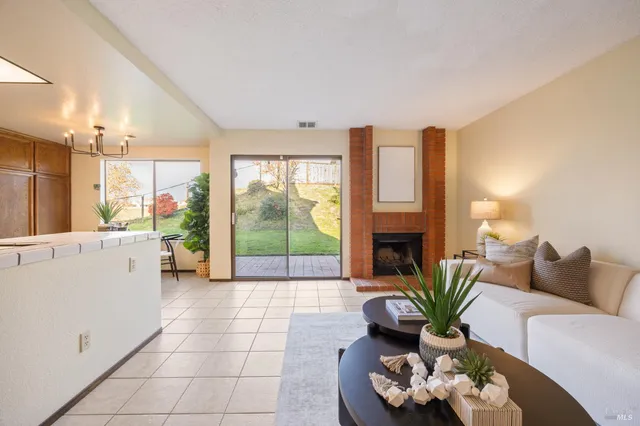 a living room with furniture and a large window with outer view