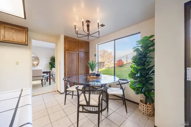 a view of a dining room with furniture window and outside view