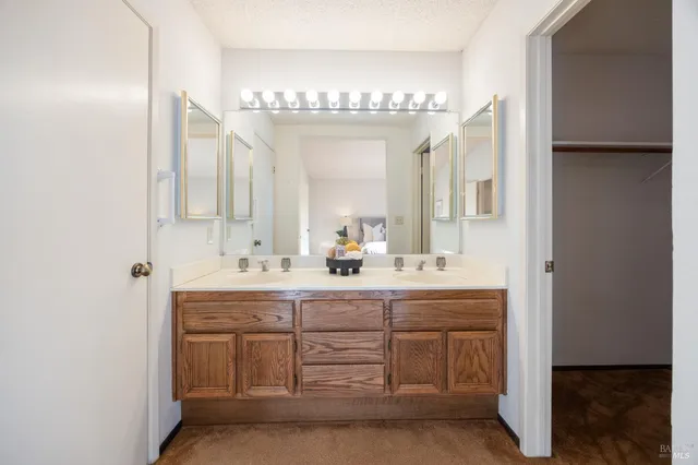 a bathroom with a double vanity sink and mirror