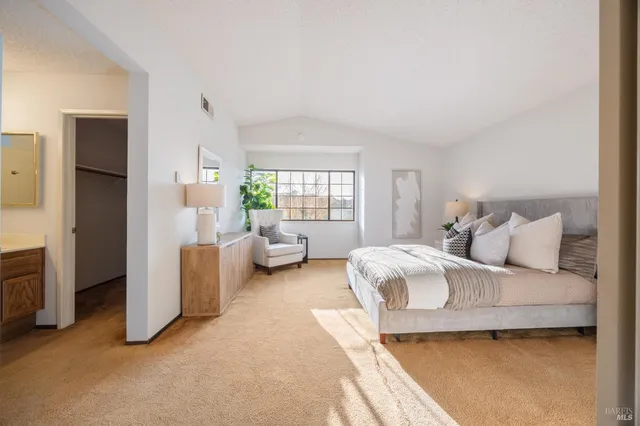 a spacious bedroom with a bed and a couch